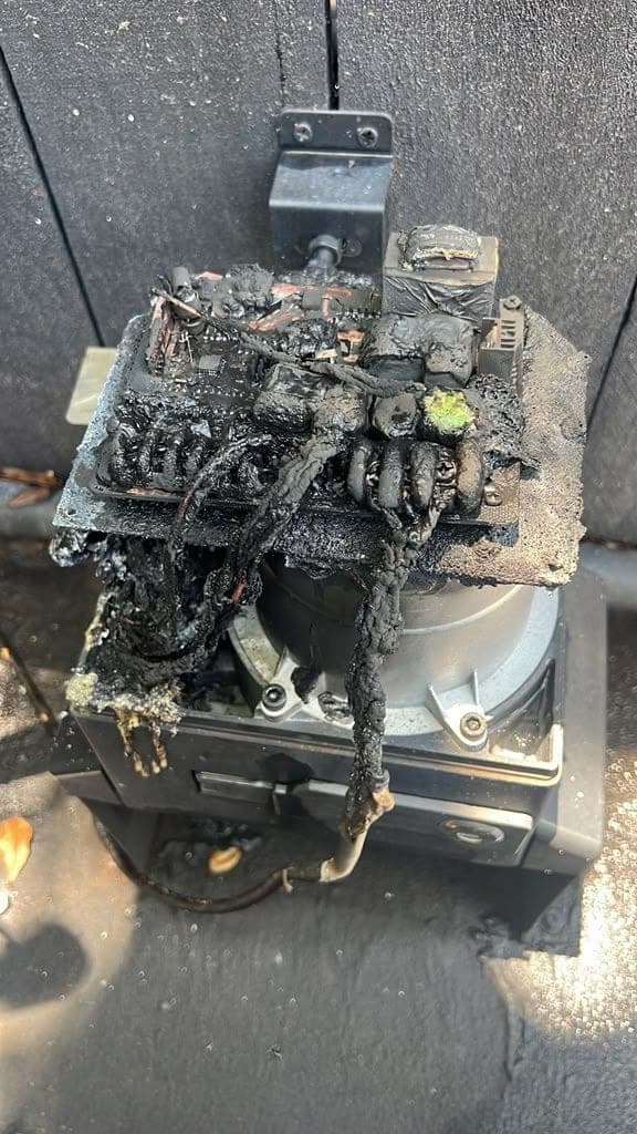 Corroded gate operator caked in oil and grime after years of coastal salt exposure