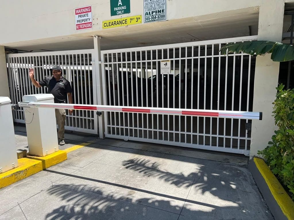 Installed barrier arm and cabinet controlling a covered parking entrance
