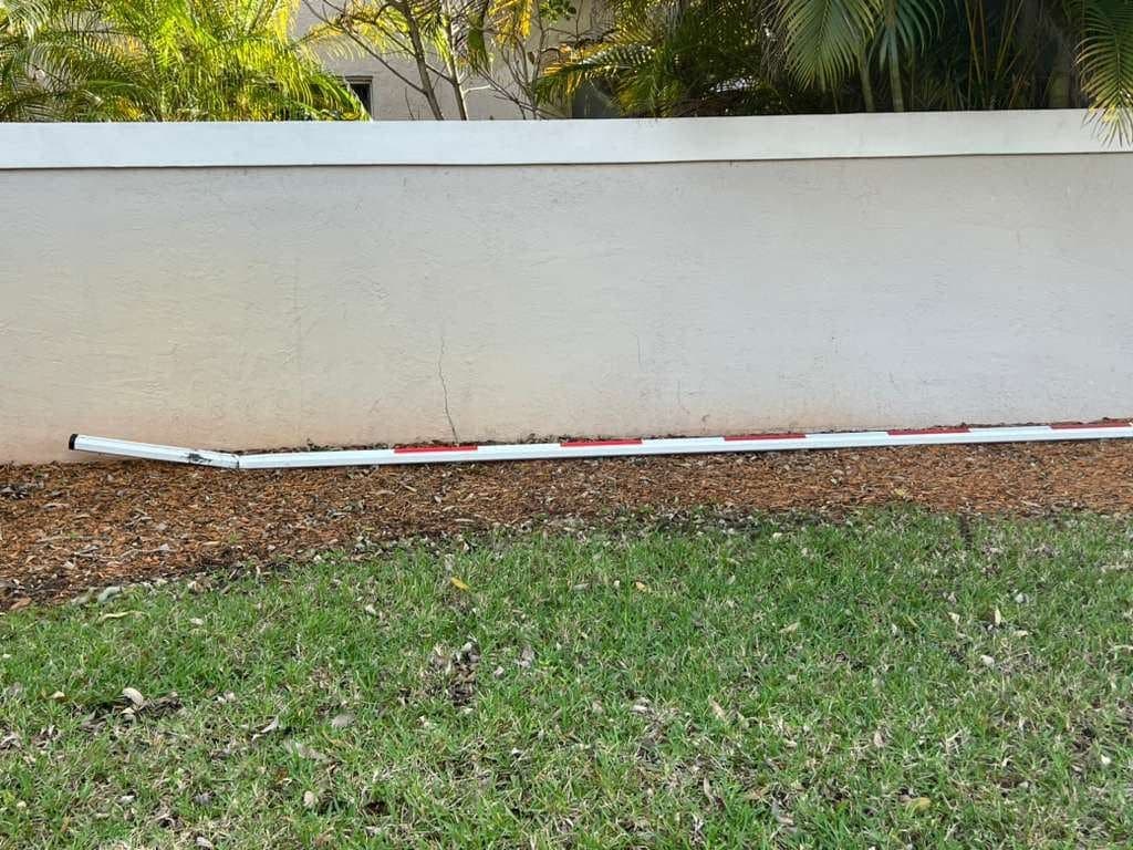 Bare wall and verge before the barrier arm and cabinet were installed