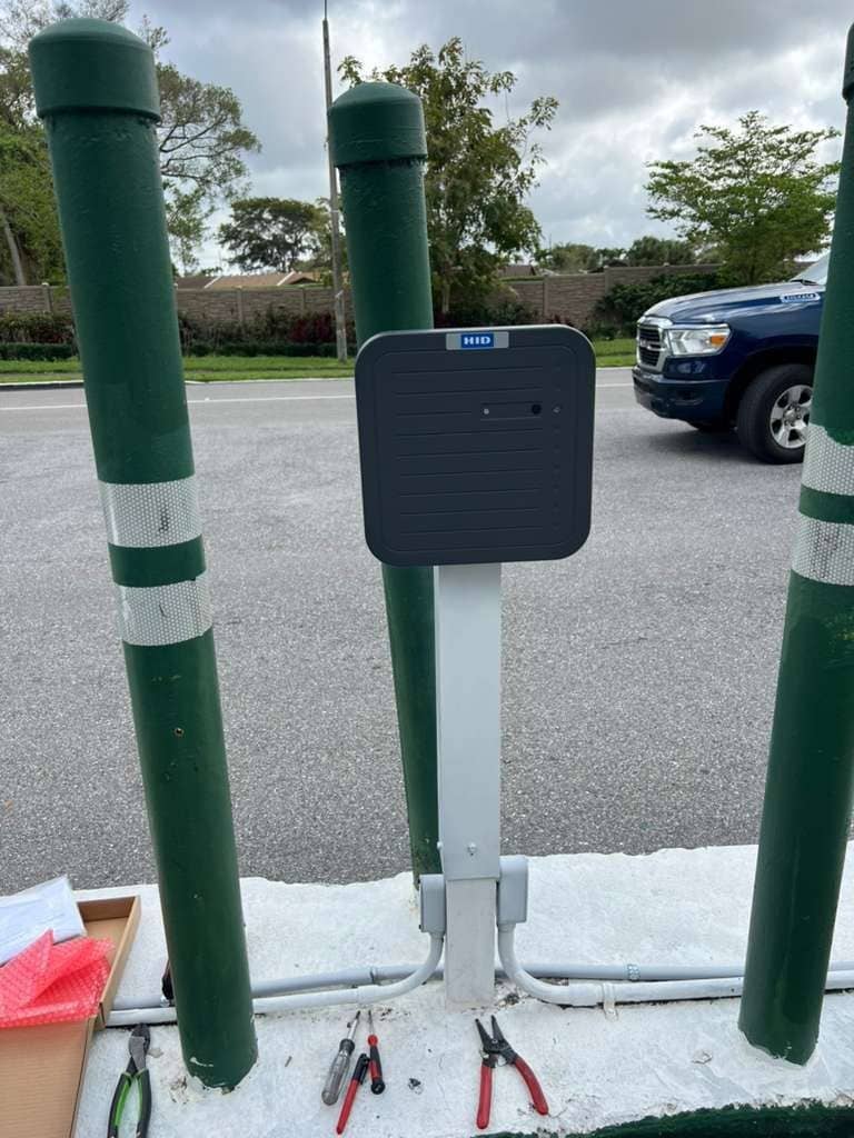 RFID reader mounted on a post between bollards at a vehicle entrance